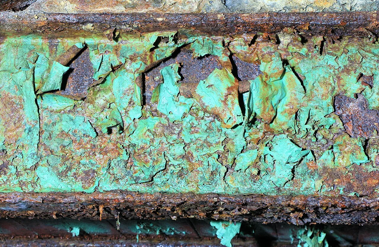 Recognising peeling coating and corrosion. Actual industrial-surface photograph, not a cargo hold. An appearance example, not an ISO preparation grade, steel-thickness assessment or repair acceptance standard.
